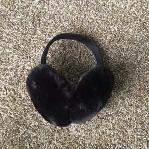 Foldable black fluffy earmuffs.